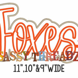 May include: A graphic design with the word "FOXES" in orange script, outlined in gray, above the words "SASSY THREADZ" in colorful, dotted letters. The text "11", 10" & 9" WIDE" is below the other text.