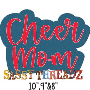 May include: A teal-coloured, cloud-shaped design with the words "Cheer Mom" in red script. Below, the text "SASSY THREADZ" is displayed in colourful, illuminated letters. The design includes the measurements 25.4cm, 22.86cm, & 20.32cm.