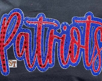 May include: Black t-shirt with the word "Patriots" in red and blue sequined lettering. The word is outlined in white. The letters have a script-like font. The letters are filled with red sequins and outlined in blue sequins.