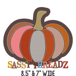 May include: A colorful, stylized pumpkin with a brown outline and a gray center. The text "SASSY THREADZ" is below the pumpkin in colorful letters with light bulbs. The text "8.5" & 7" WIDE" is below the text "SASSY THREADZ".