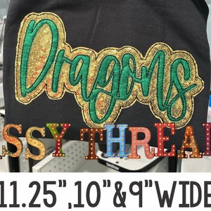 May include: Gold and green sequined "Dragons" embroidery on a black fabric background. The embroidery is 11.25 inches, 10 inches, and 9 inches wide. The text "SASSY THREADZ" is below the embroidery in colorful letters with gold accents.