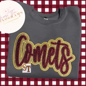 May include: Gray sweatshirt with a maroon and gold glitter "Comets" design.