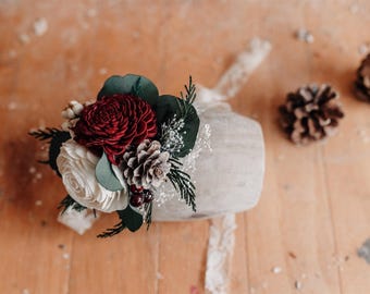 Wood Flower Winter Wrist Corsage with Preserved Cedar and Pine Cones in shades of Red and Ivory