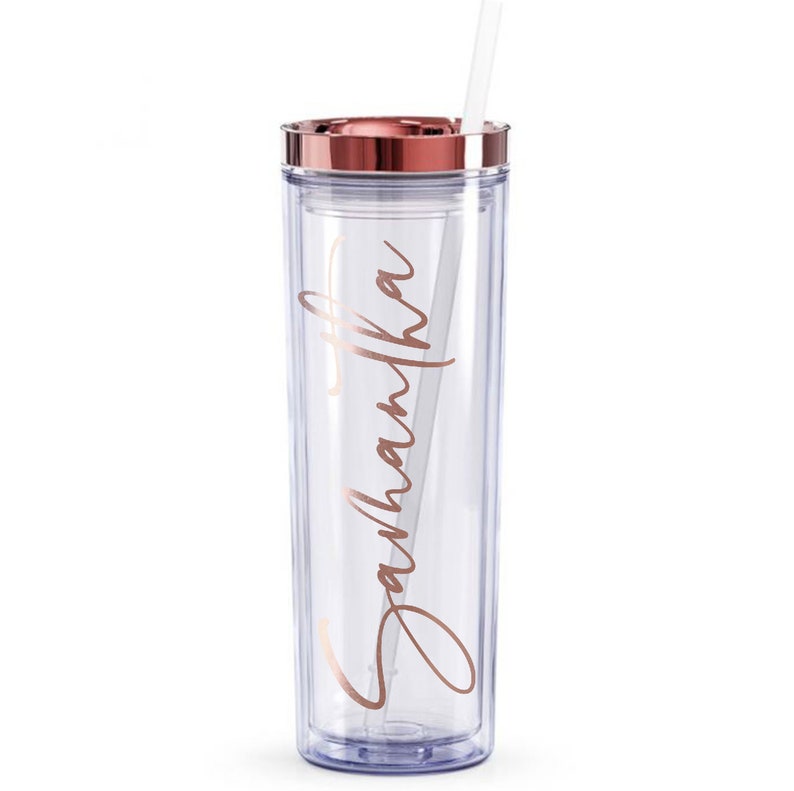 May include: A clear, reusable tumbler with a rose gold lid and straw. The tumbler has the name "Samantha" written on it in rose gold lettering.