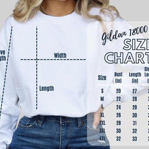 Puede incluir: Una tabla de tallas para sudadera Gildan 18000 blanca con un diagrama de l&iacute;neas discontinuas que indica el ancho, largo y largo de manga en pulgadas. La tabla enumera las tallas de la S a la 4XL con medidas de busto y largo correspondientes.