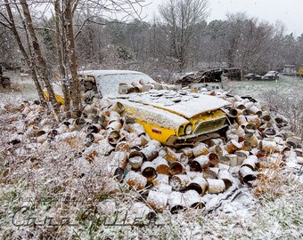 Photograph of a 1973-1974 Yellow Dodge Challenger Buried in Tin Cans and Snow