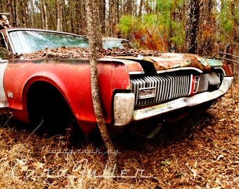 Photograph of a Red 1968 Mercury Cougar GT in the woods
