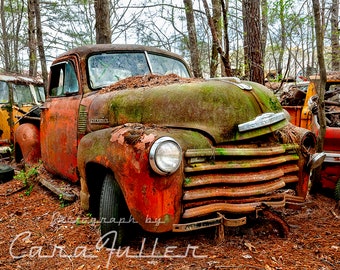 Photograph of a 1950-1952 Red Chevy Truck with Five Windows in The Woods