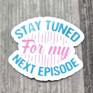 May include: A blue and white sticker with the text "Stay Tuned For My Next Episode" in a curved design. The text "For My" is in pink.