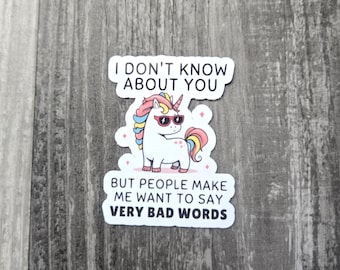 May include: A white sticker with the text "I DON'T KNOW ABOUT YOU" and "BUT PEOPLE MAKE ME WANT TO SAY VERY BAD WORDS". The sticker features a cartoon unicorn wearing sunglasses.