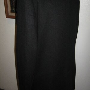 May include: A black blazer with a smooth, textured fabric. The blazer has a classic, tailored fit.