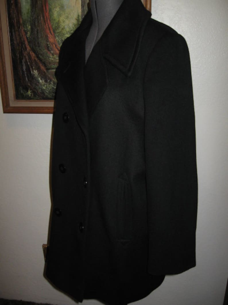 May include: A black peacoat with a double-breasted closure and a single pocket on the left side.
