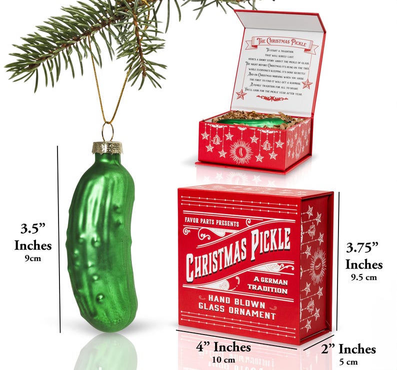 May include: A green glass Christmas pickle ornament in a red box with white lettering that reads "Favor Parts Presents Christmas Pickle A German Tradition Hand Blown Glass Ornament". The ornament is 9 cm tall and the box is 10 cm wide and 5 cm tall.