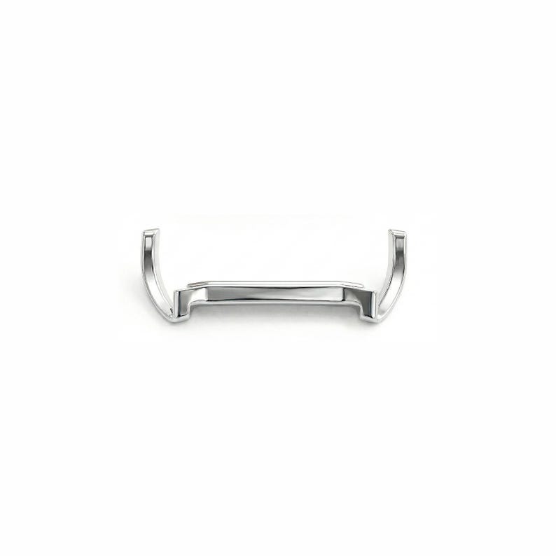 May include: A shiny, silver-colored metal watch buckle with a rectangular center and curved ends. The buckle is designed to attach a watch strap and is set against a plain white background.