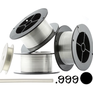 May include: Three spools of silver wire, each with a black plastic spool and a silver wire. A silver rod is also shown in the image. The text .999 is visible in the image.