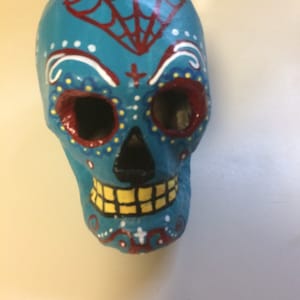 Hand-painted sugar skull in teal