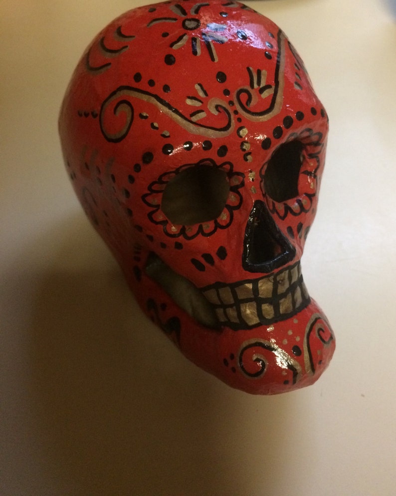 Hand-painted paper mâché sugar skull in red image 1