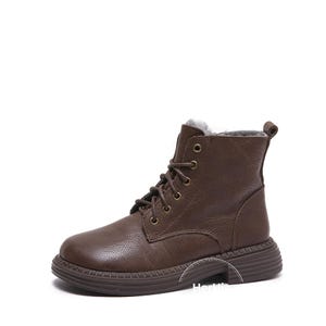 May include: Brown leather ankle boots with a lace-up closure and a thick rubber sole. The boots have a faux fur lining.