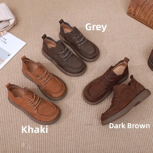 May include: A selection of leather shoes in shades of grey, khaki, and dark brown. The shoes feature a traditional lace-up style and a rounded toe. The image is labelled with the shoe colours.