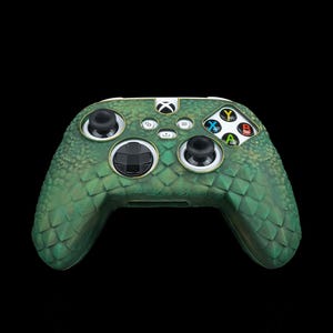 May include: A green and white Xbox controller with a textured, snake-skin design.