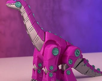 May include: A purple and silver dinosaur toy with articulated joints. The dinosaur has a long neck and tail, and green accents on its body.
