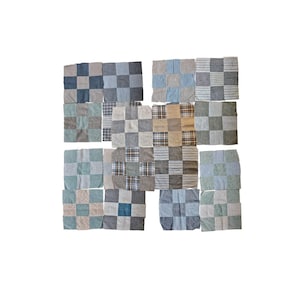 May include: A collection of patchwork squares in various shades of blue, gray, and beige. Each square is composed of smaller fabric pieces, creating a checkered pattern. The fabrics include stripes, checks, and solid colors, offering a rustic, handcrafted aesthetic.
