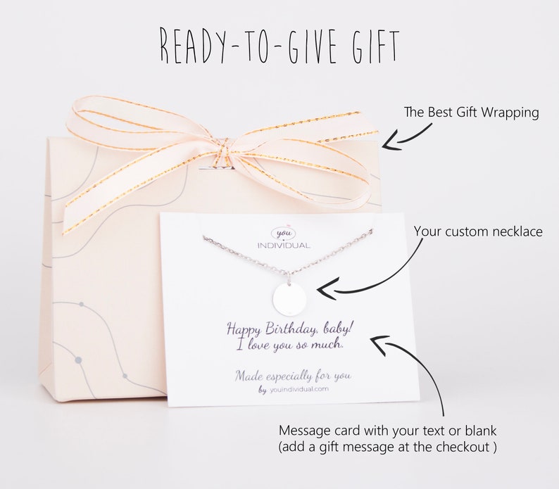 May include: A gift box with a white card and a silver necklace with a round pendant. The card has a message that says "Happy Birthday, baby! I love you so much. Made especially for you by youindividual.com".