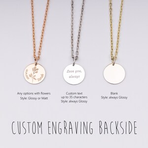 May include: Three silver necklaces with round pendants. The pendant on the left has a floral design and the text "Sarah" engraved on it. The middle pendant has the text "Love you, always" engraved on it. The pendant on the right is blank.