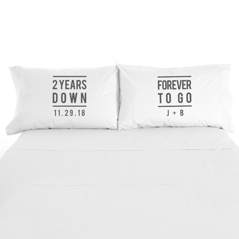 May include: Two white pillowcases with black text. The left pillowcase says "2 Years Down 11.29.18". The right pillowcase says "Forever To Go J + B".
