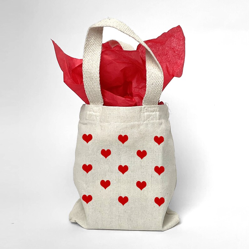 Decorate your heart gift bag with colorful red tissue.