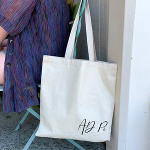 Cotton canvas tote bag with the AD Pi sorority nickname printed on the front of the bag