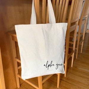 Alpha Gamma Delta medium canvas tote bag featuring a sweet sorority nickname in script.
