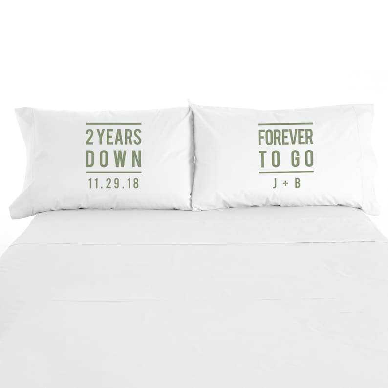 May include: Two white pillowcases with green text. The left pillowcase says "2 Years Down 11.29.18". The right pillowcase says "Forever To Go J+B".