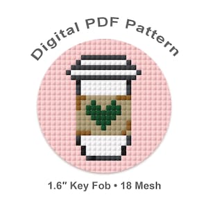 May include: A digital PDF pattern for a key fob. The design features a pixelated coffee cup with a green heart on a pink background. The text "Digital PDF Pattern" is arched above the image. The key fob is 1.6 inches in diameter.