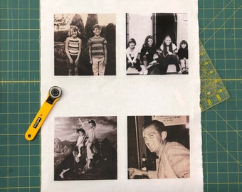 May include: Four black and white photographs are displayed on a white fabric background. The photos are arranged in a grid of two rows and two columns. The photos show a group of people, a couple, a man, and a group of children.