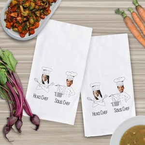 May include: Two white kitchen towels with a black and white illustration of chefs with faces inserted. The text on the towels reads "Head Chef" and "Sous Chef".
