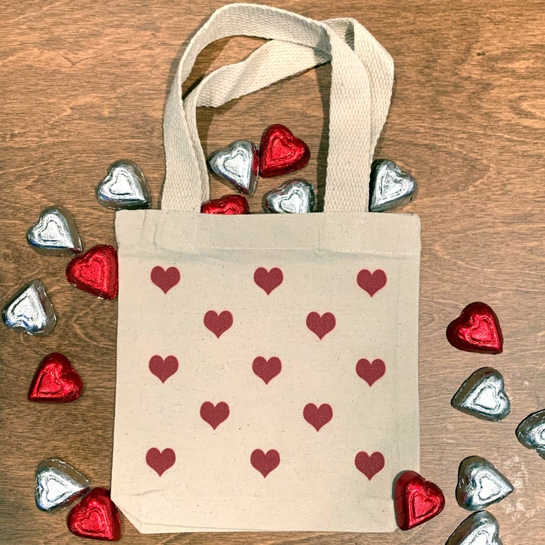 The red hearts are printed directly on the surface of the mini tote bag with eco friendly apparel inks