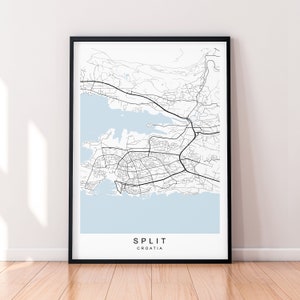 May include: A black and white map print of Split, Croatia, with a light blue background. The map shows the city's streets and coastline. The text "SPLIT" and "CROATIA" is printed below the map.
