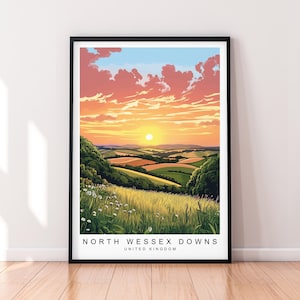 Peut inclure: Une affiche encadrée représentant un paysage des North Wessex Downs, Royaume-Uni. L'œuvre montre un coucher de soleil sur des collines et des champs verdoyants, avec un ciel orange et rose. Le texte "NORTH WESSEX DOWNS UNITED KINGDOM" est inclus.