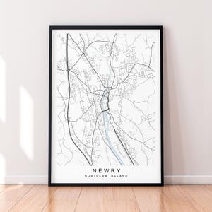 May include: A black and white map print of the city of Newry, Northern Ireland. The map shows the streets and roads of the city.