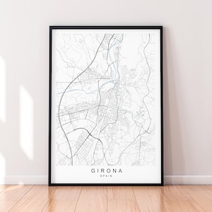 May include: A black and white line art map of Girona, Spain. The map shows the city's streets and waterways. The city name and country are printed below the map.