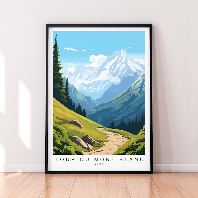 May include: A framed art print featuring a scenic mountain landscape with a path leading through a valley. The artwork depicts the Tour du Mont Blanc in the Alps, with text at the bottom. The color palette includes shades of green, blue, and white.