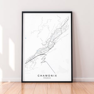 May include: A black and white line art map of Chamonix, France, printed on white paper and framed in a black frame.