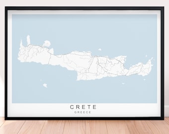 May include: A black framed print of a map of Crete, Greece. The map shows the island's roads and coastline. The text "CRETE" and "GREECE" is printed below the map.