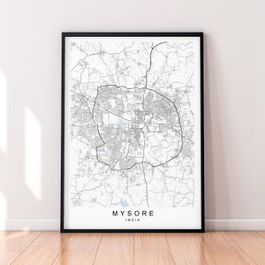 May include: Black and white city map print of Mysore, India. The map shows the city streets and landmarks. The city name is printed in blue below the map.