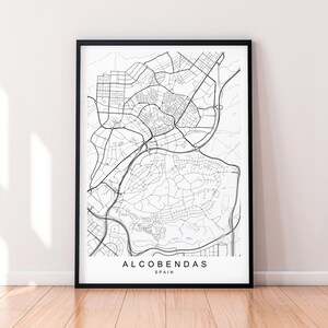 May include: A framed black and white map print of Alcobendas, Spain. The detailed cartography shows roads, buildings, and geographical features. The city name and country are printed at the bottom.