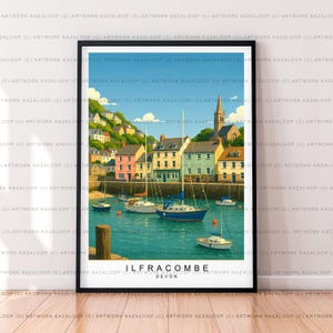 May include: A framed art print depicting Ilfracombe, Devon, with a harbor scene. The image shows colorful buildings, sailboats, and a church spire against a blue sky. The text "ILFRACOMBE DEVON" is included.