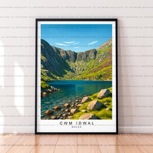 May include: A framed print of Cwm Idwal, Wales, showcasing a tranquil lake nestled amidst rugged mountains under a blue sky. The artwork includes the text "CWM IDWAL WALES" at the bottom, a scenic landscape.