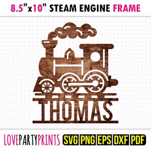 May include: A wooden steam engine frame, 8.5" x 10", with the name "THOMAS" cut out below the train. The train is brown with white accents and smoke. The text "STEAM ENGINE FRAME" is above the train.