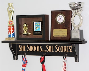 She shoots... She scores!  - Trophy Shelf